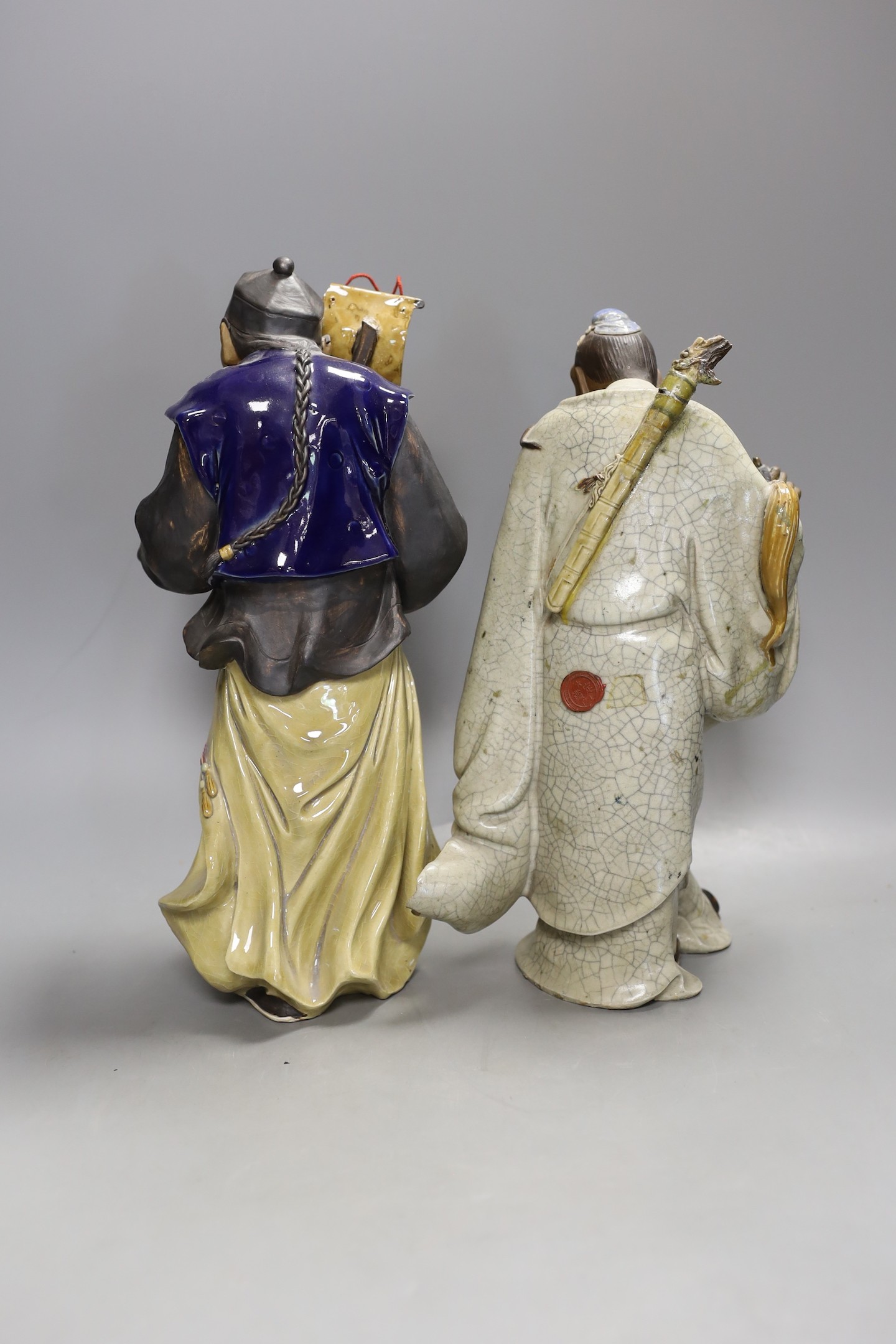Two large Chinese Shiwan pottery figures of Lu Dongbin and an official - tallest 32cm